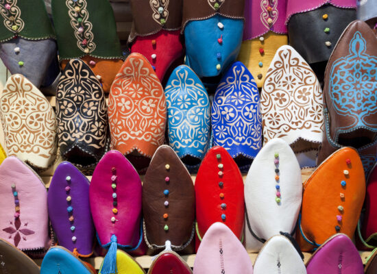 High angle close up of colourful leather slippers at a traditional North African market.